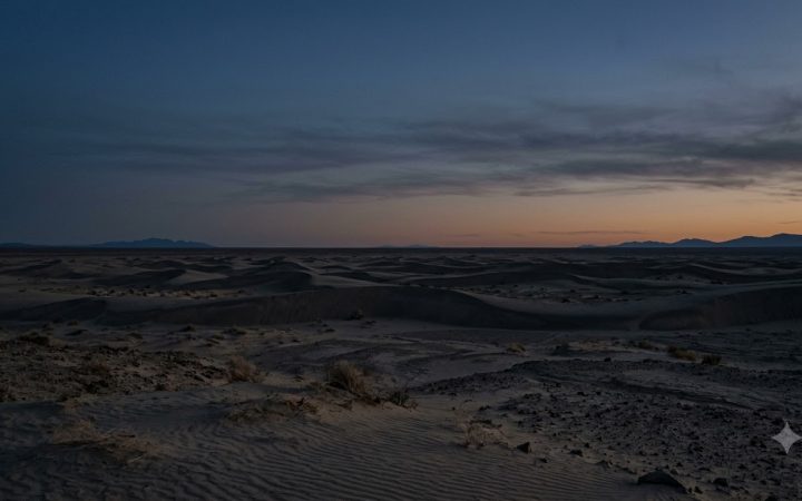 Cinematic wide shot of a vast, desolate desert landscape under a twilight sky, deep silence, emptiness, desaturated colors, natural lighting, high res
