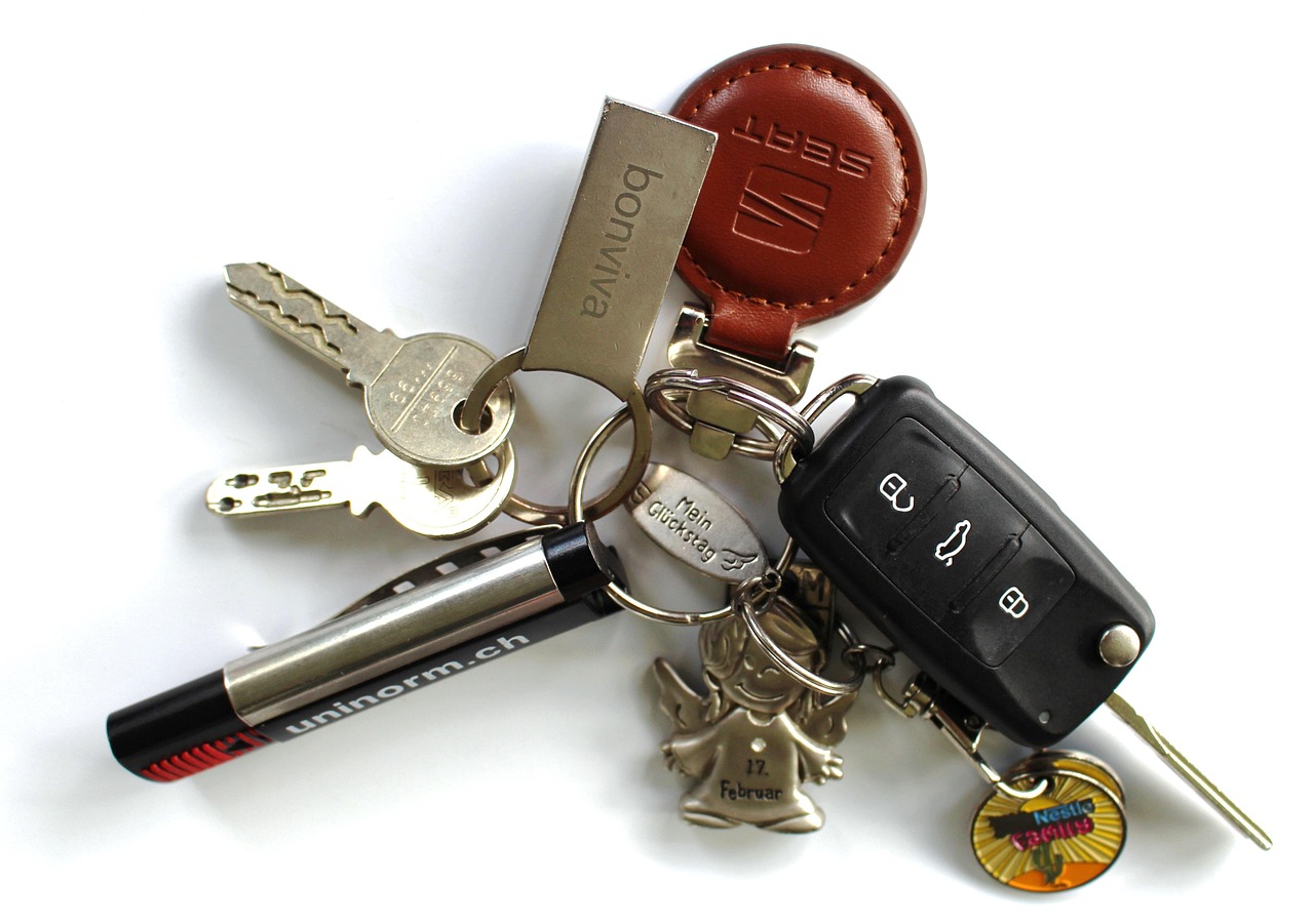 A factory original car key fob compared alongside an aftermarket key replacement fob.