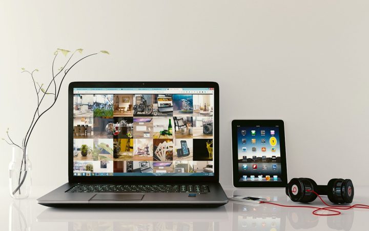 A modern executive workstation with a laptop open to a clean calendar schedule display