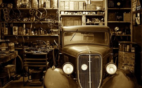 A high-end modified vehicle parked inside a clean professional automotive workshop.