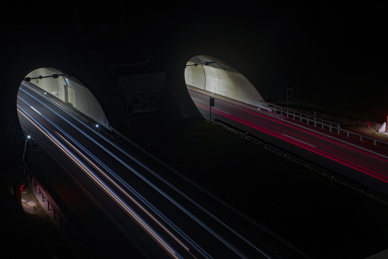 An open American highway stretching into the distance under morning sunshine.