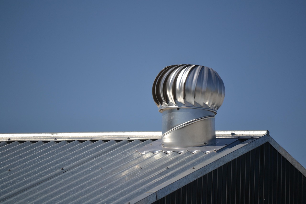 Exterior roof vent cap on a shingled roof