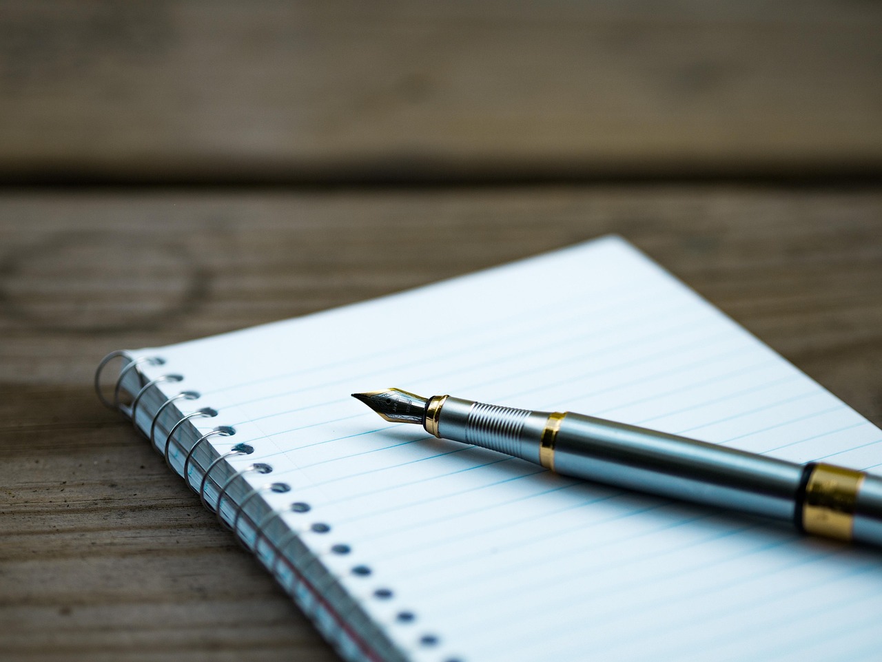 A written investment policy statement open on a wooden desk with a pen.