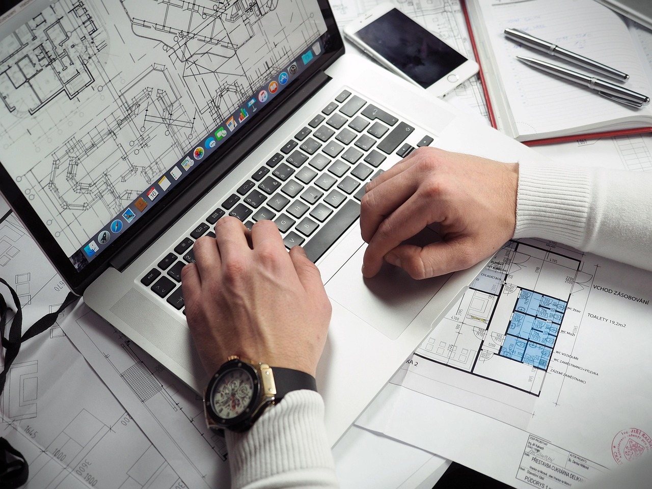 Close-up of hands working at a custom workstation keyboard.
