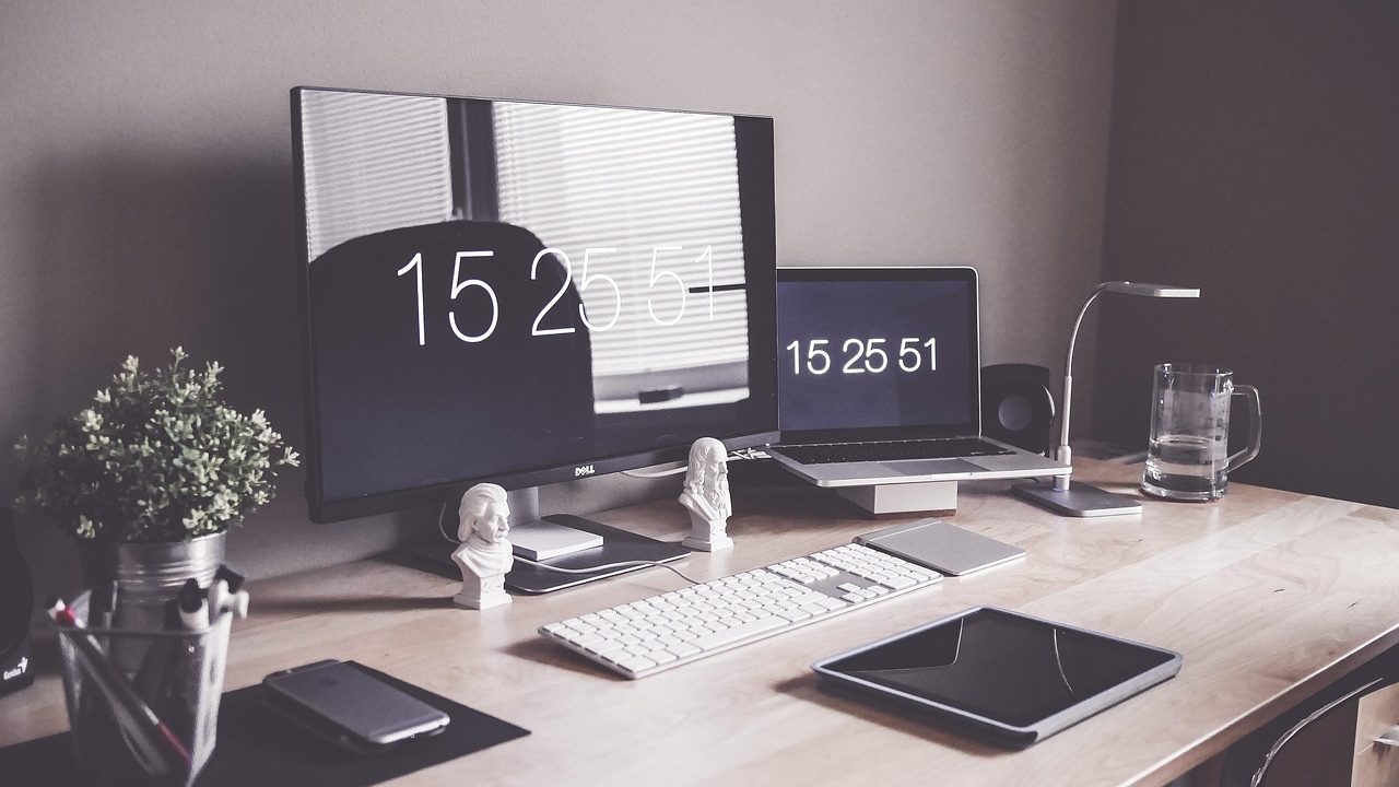 Minimalist desk setup with a keyboard and mug, representing an efficient text expansion setup.