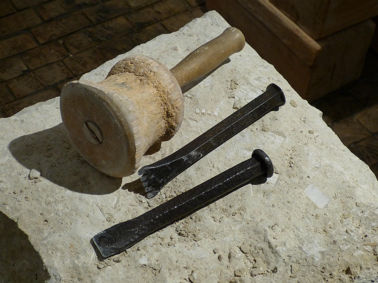 Close-up of hand tools used for raking out old mortar joints