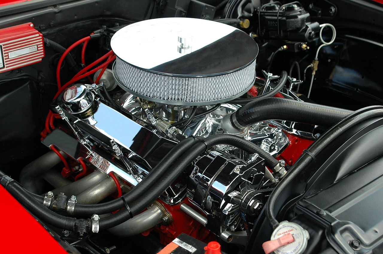 A mechanic inspecting the engine bay of a retired fleet vehicle.