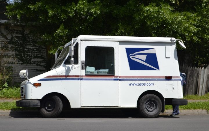 A retired postal delivery vehicle parked on a residential street.
