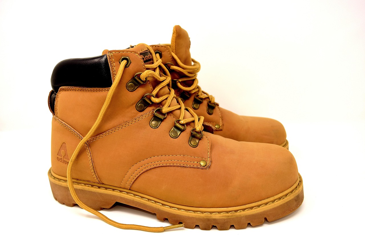 Close-up of a consumer checking the outsole wear on a pair of hiking boots.