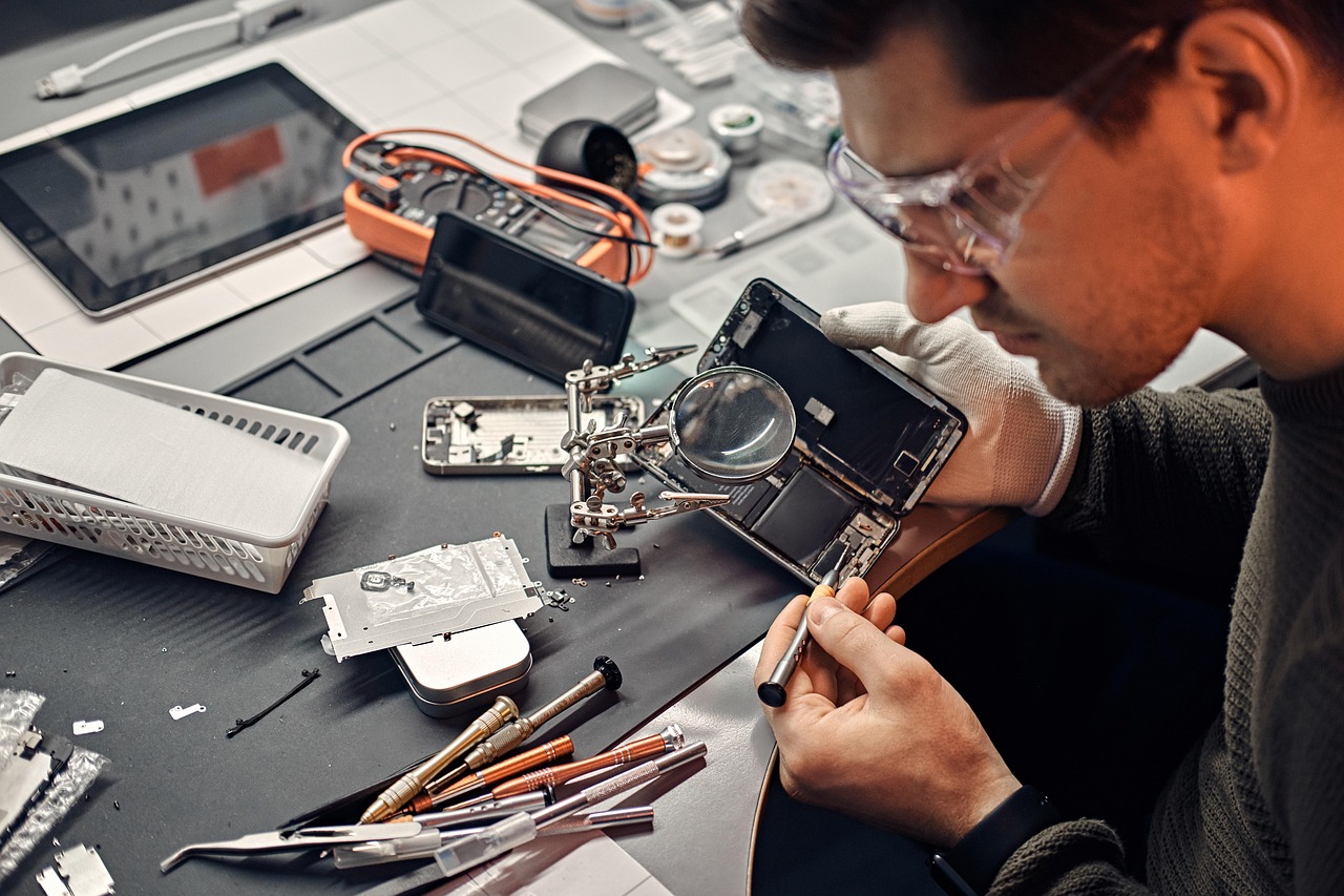 An auto glass technician using specialized tools to repair a chip in a car windshield.