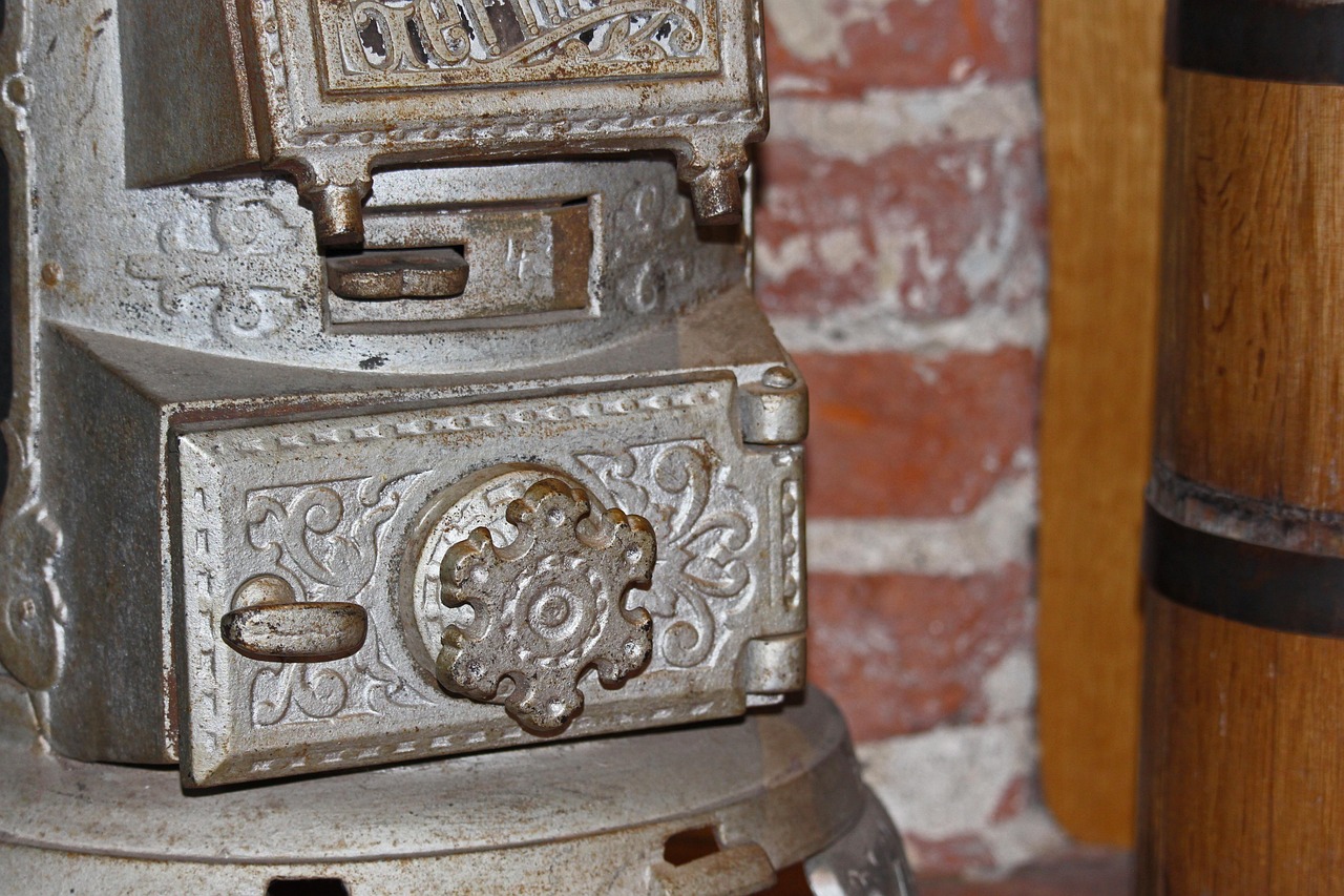 Applying torch heat to the outer hub of a cast iron cleanout pipe fitting to break rust bond.