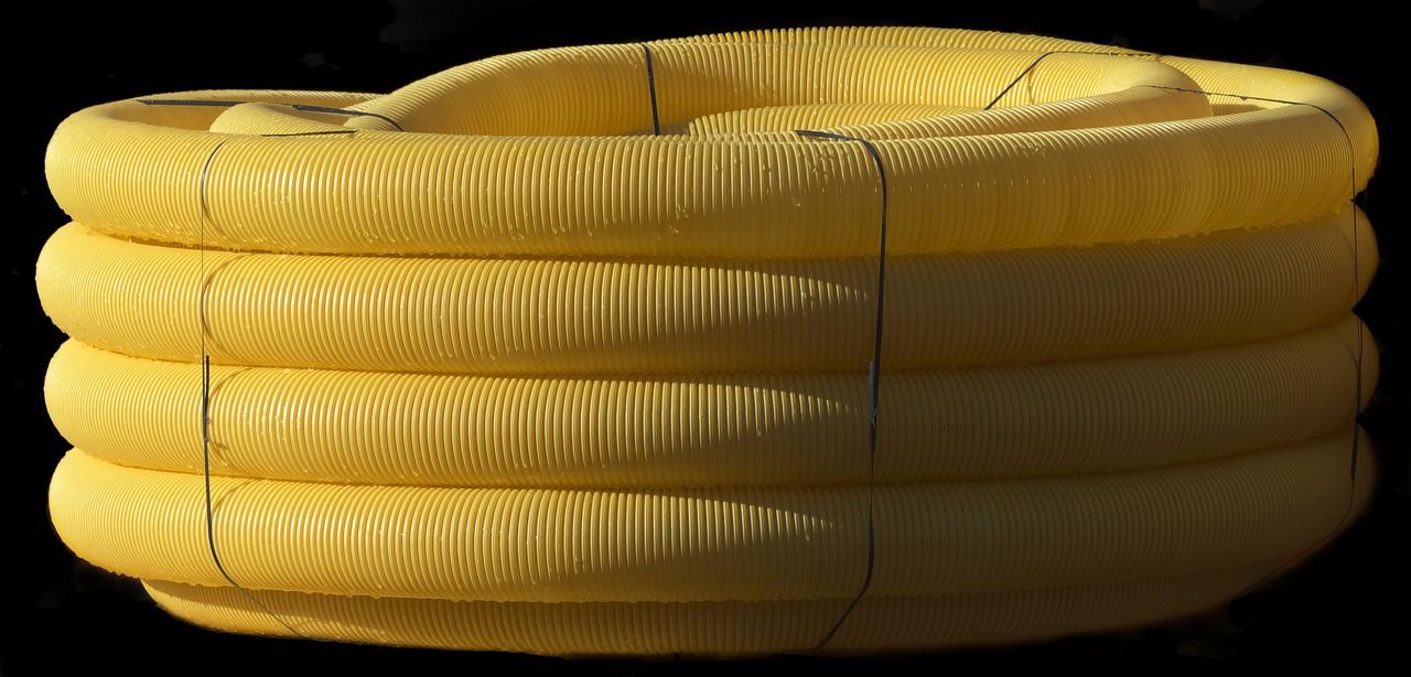 New PVC cleanout riser connected to cast iron pipe stub with a stainless steel shielded coupling.