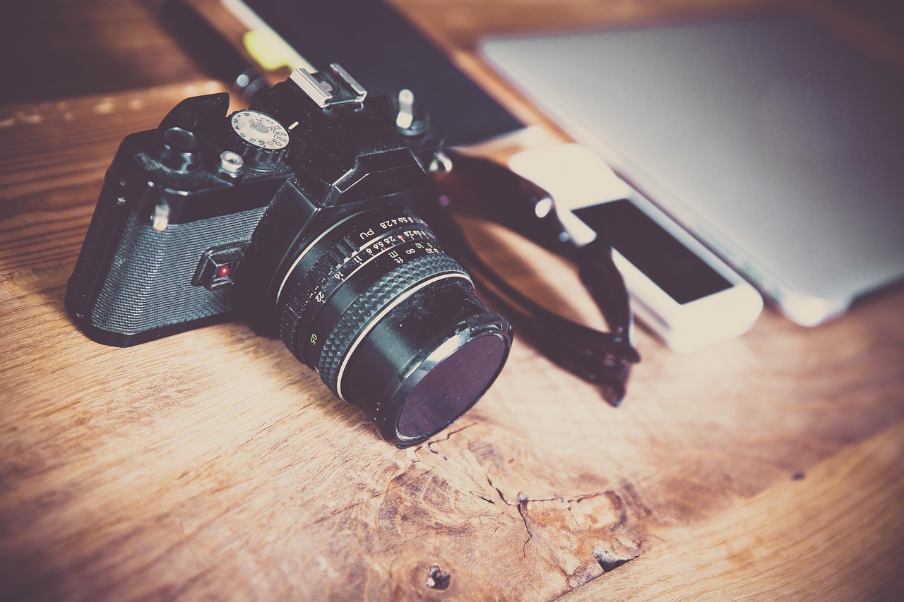 Used mirrorless cameras displayed on a retail shelf