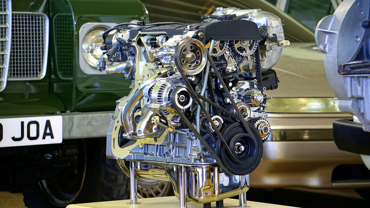 An automotive technician inspecting the engine bay of a certified pre-owned vehicle.