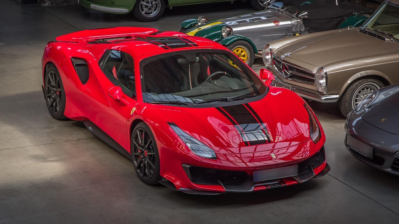 A clean car dealership showroom with a vehicle and a purchase agreement on a desk.