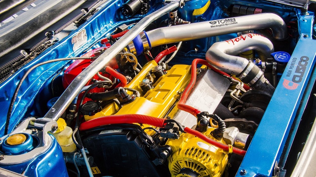 Car buyer reviewing engine compartment during a vehicle purchase inspection