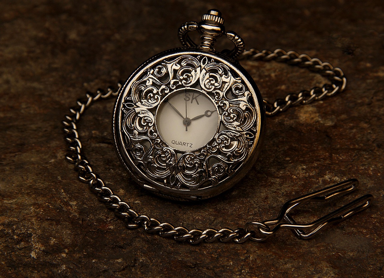 Close-up of a watchmaker examining a dial with a loupe