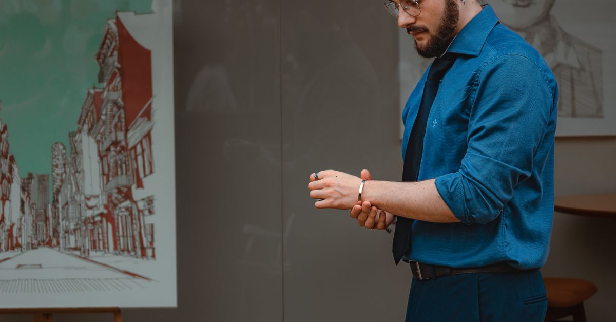 Customer trying on a luxury watch at a retail counter