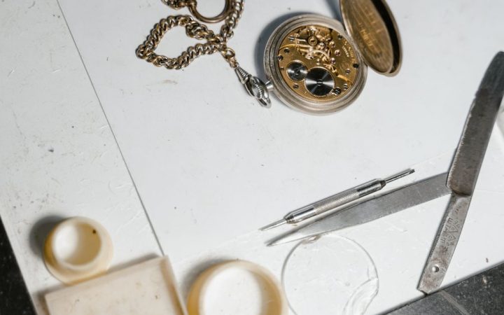 Watchmaker working on a mechanical movement at a workbench