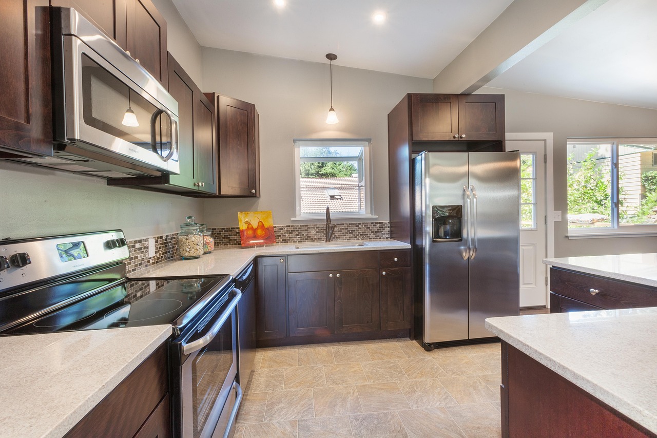 A modern kitchen with clean stainless steel major appliances ready for home use.