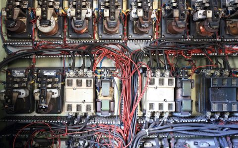Open residential electrical service panel showing breakers, neutral wiring, and bus bar.