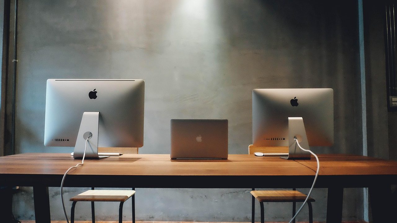 A professional desk setup in an office building showing financial documents and digital devices.