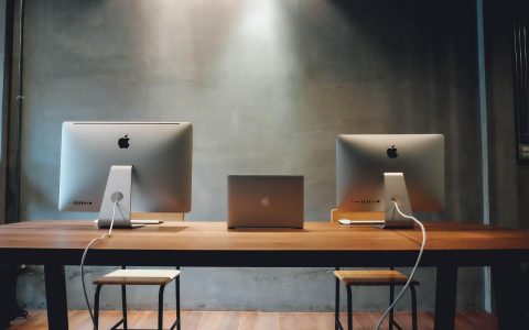 A professional desk setup in an office building showing financial documents and digital devices.