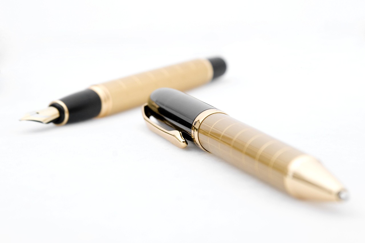 Fountain pen lying across formal legal and financial equity contracts.