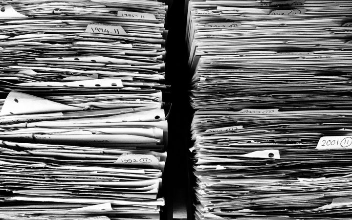 Severance documents and equity agreement paperwork on a desk in a corporate office setting.