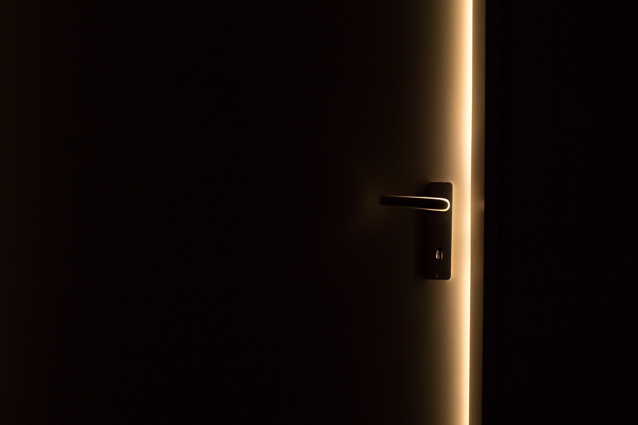 Homeowner opening a refrigerator door to check interior shelf depth