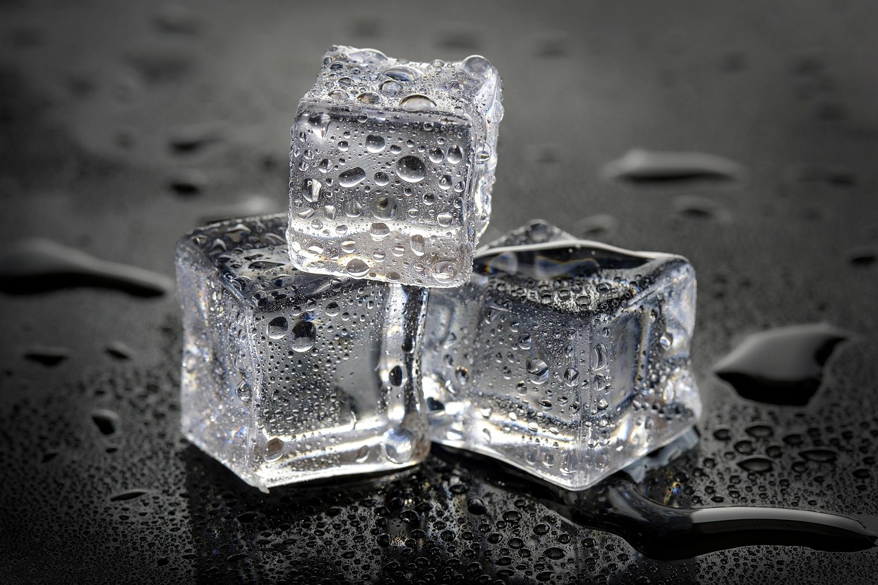 Close-up of a standard refrigerator door ice and water dispenser.