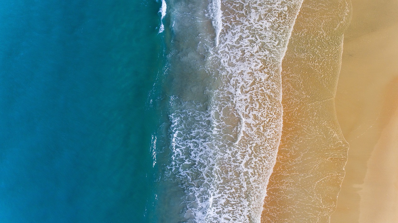 Applying spray foam insulation to seal rim joists in a crawlspace.