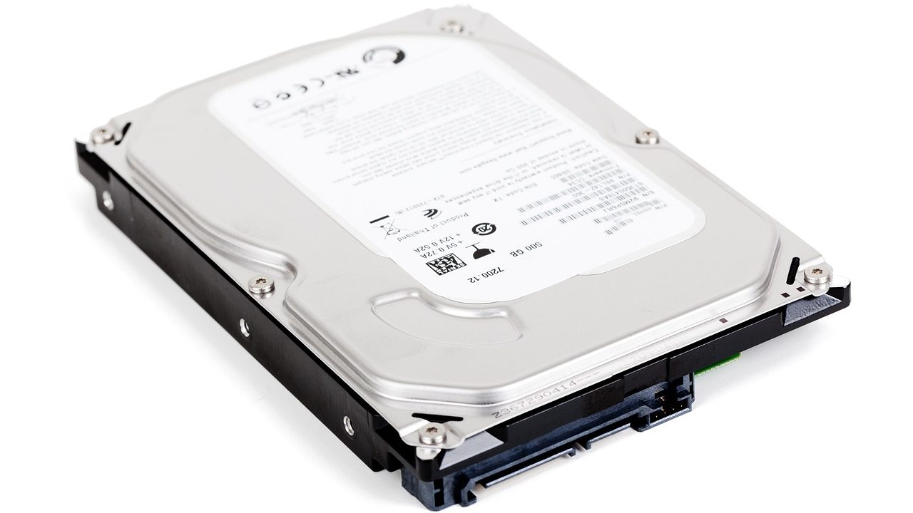 External hard drive connected to a laptop on a wooden desk