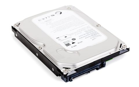 External hard drive connected to a laptop on a wooden desk