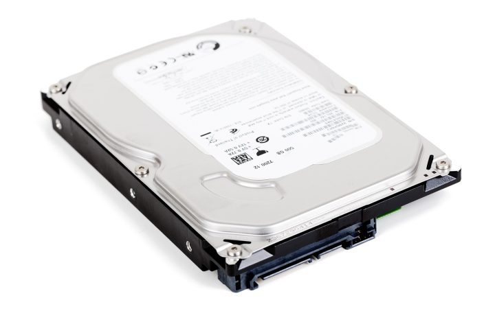 External hard drive connected to a laptop on a wooden desk