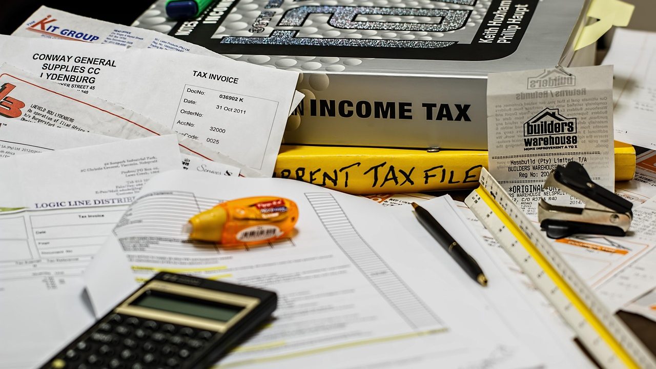 Official vehicle registration forms and financial hardship waiver paperwork neatly arranged on a desk