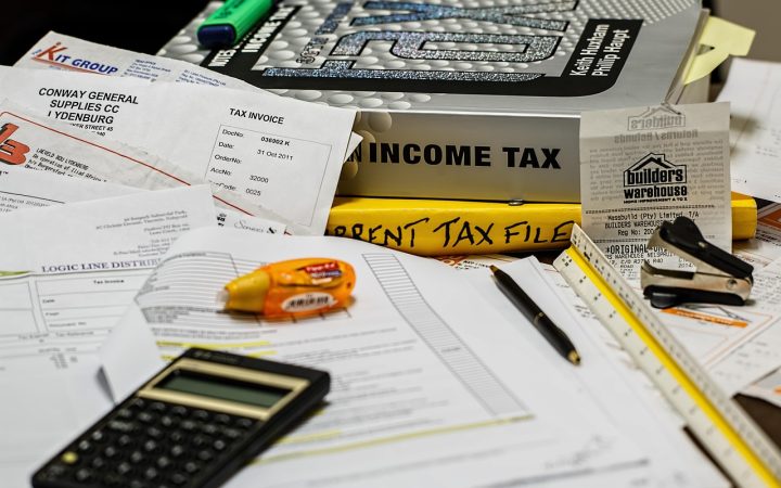 Official vehicle registration forms and financial hardship waiver paperwork neatly arranged on a desk