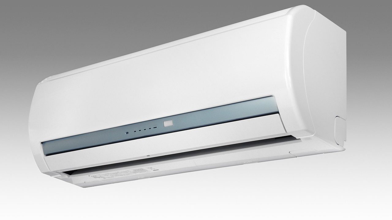 Portable air conditioner installed in a room with window hose connection