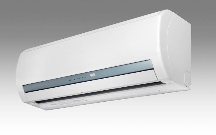Portable air conditioner installed in a room with window hose connection