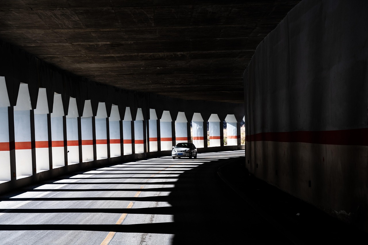 Vehicle traveling at highway speeds beneath high-speed overhead electronic toll readers.