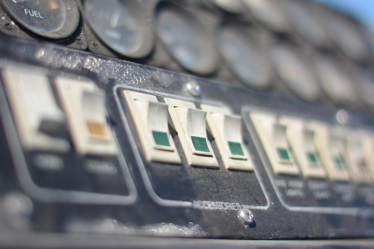 An open main electrical breaker panel showing labeled circuit switches inside a residential home.
