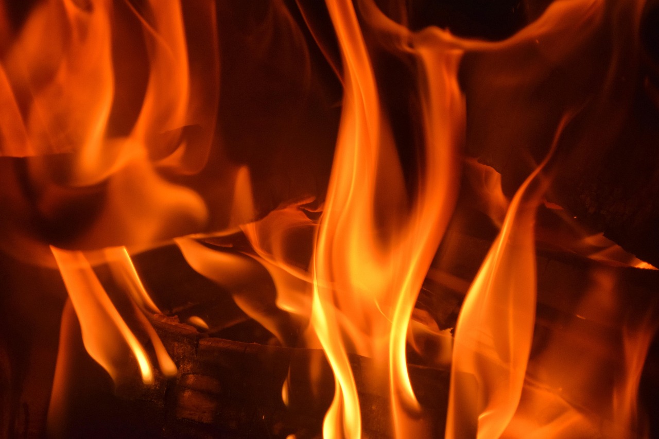 Close-up view of a damaged electric oven heating element featuring scorched metal and a visible crack.
