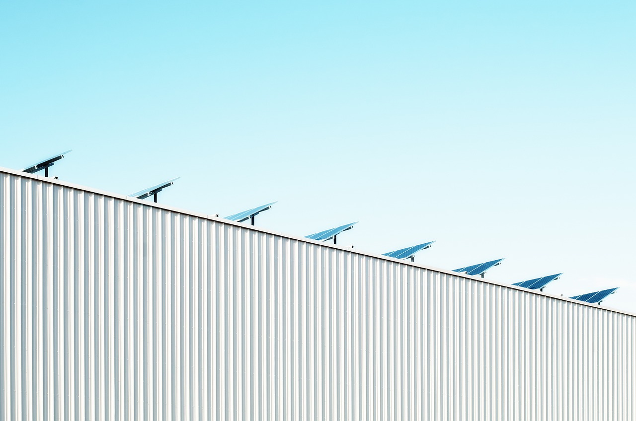 Rooftop solar panels on a suburban house under bright daylight.
