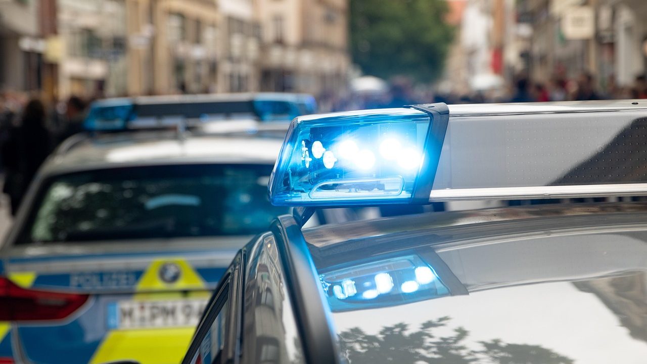 A police car pulled up behind a sedan during a routine roadside traffic stop.