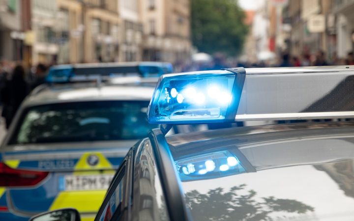 A police car pulled up behind a sedan during a routine roadside traffic stop.