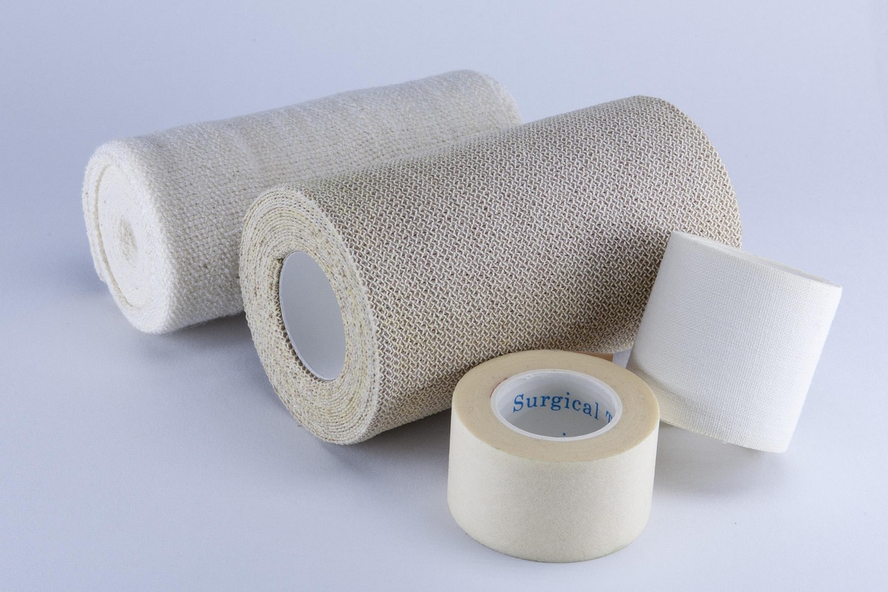 Organized medical syringes, veterinary liquid diet, gauze, and wrap supplies arranged neatly on a towel.