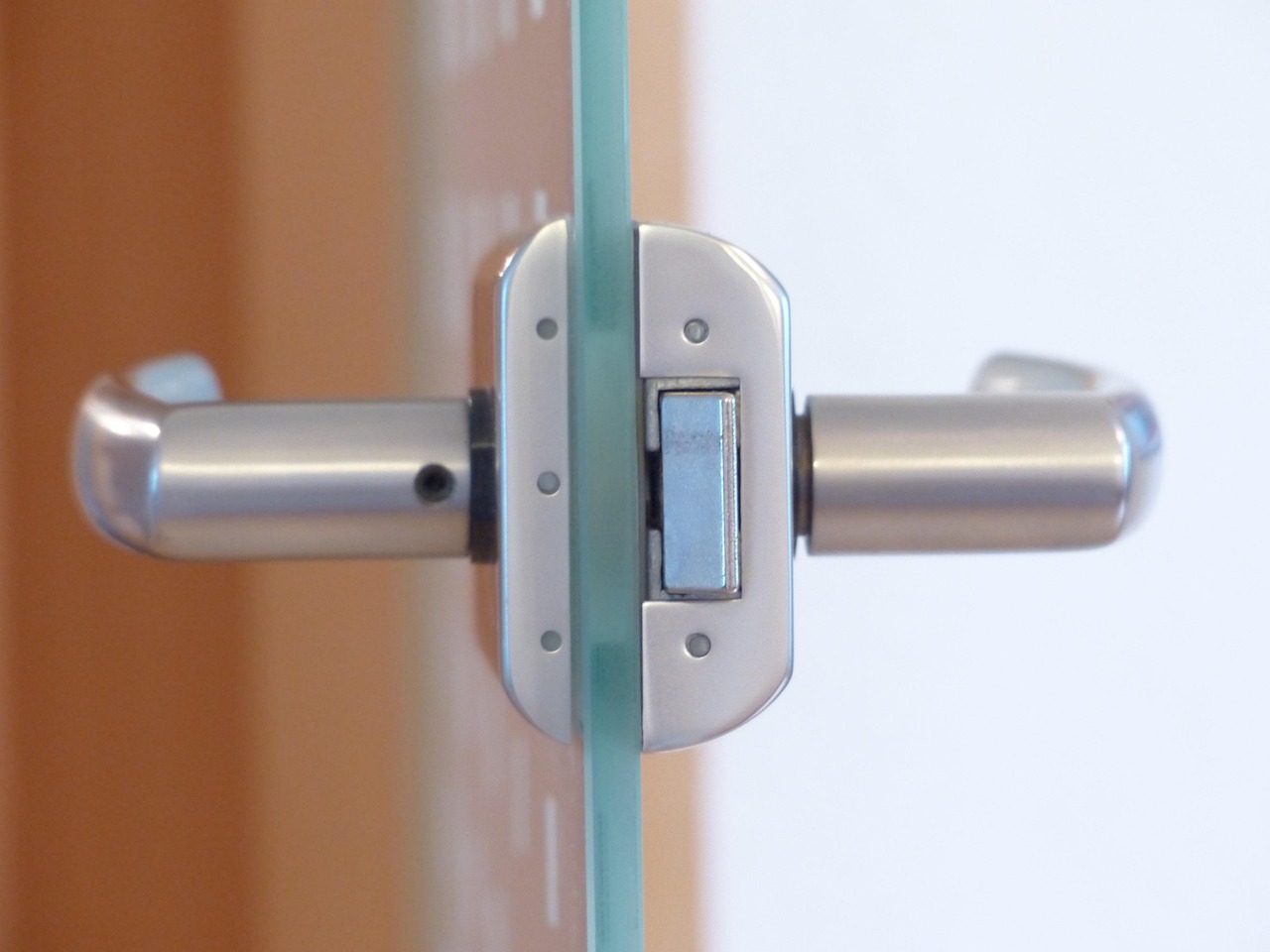 A contractor applying a protective finish to an exterior entry door.