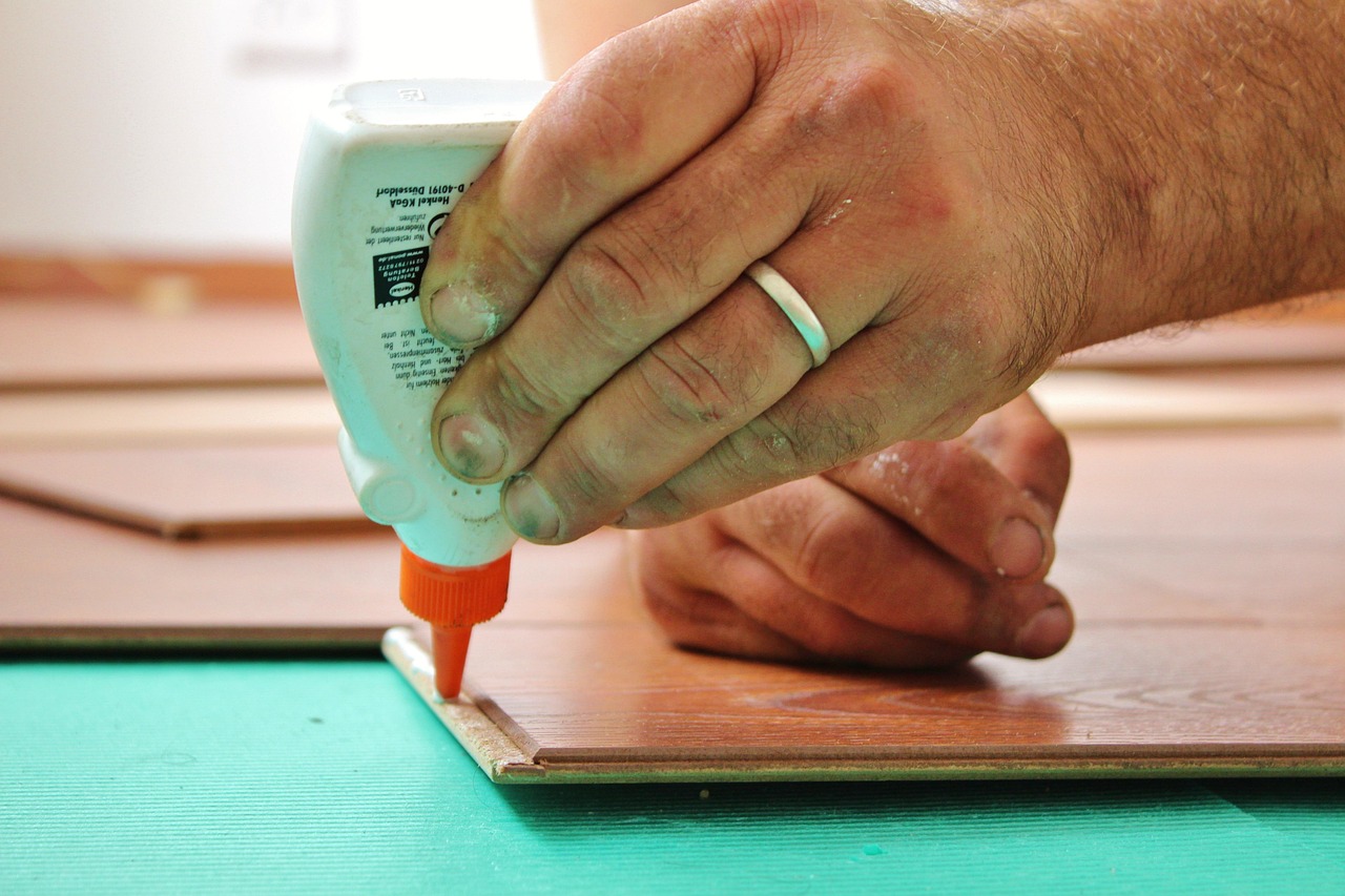 Applying structural wood glue into the joint of a loose stair spindle.