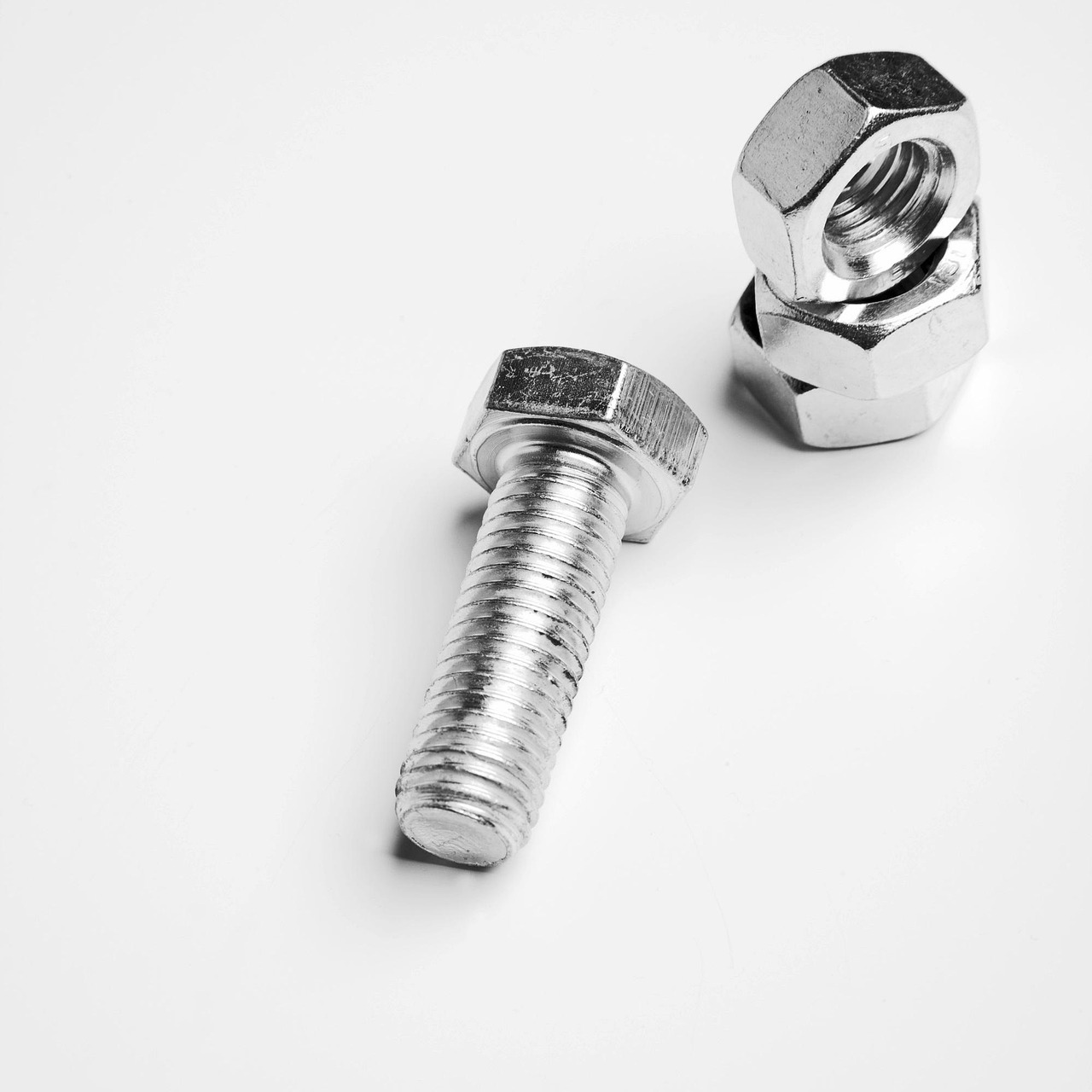Tightening mounting screws on a wooden staircase handrail bracket.