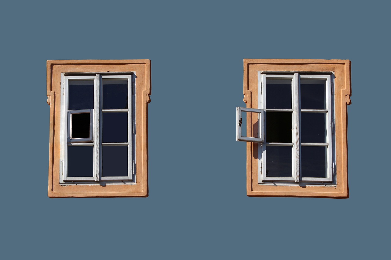 Contractor installing a new full-frame replacement window on a house exterior